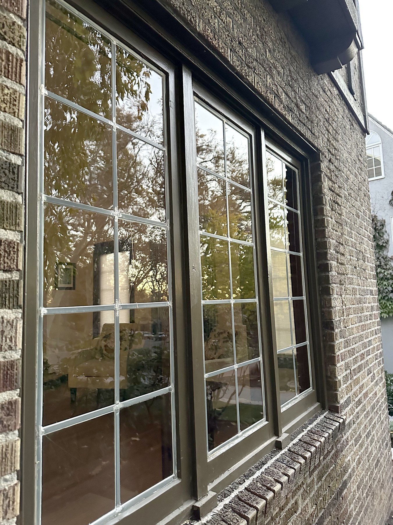 Divided light windows on a brick home after exterior cleaning