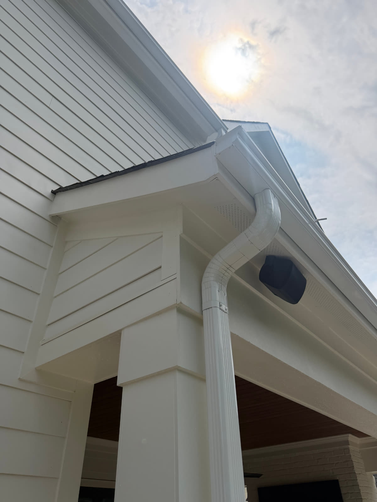 Clean white gutter, downspout, and soffit on a Charlotte home