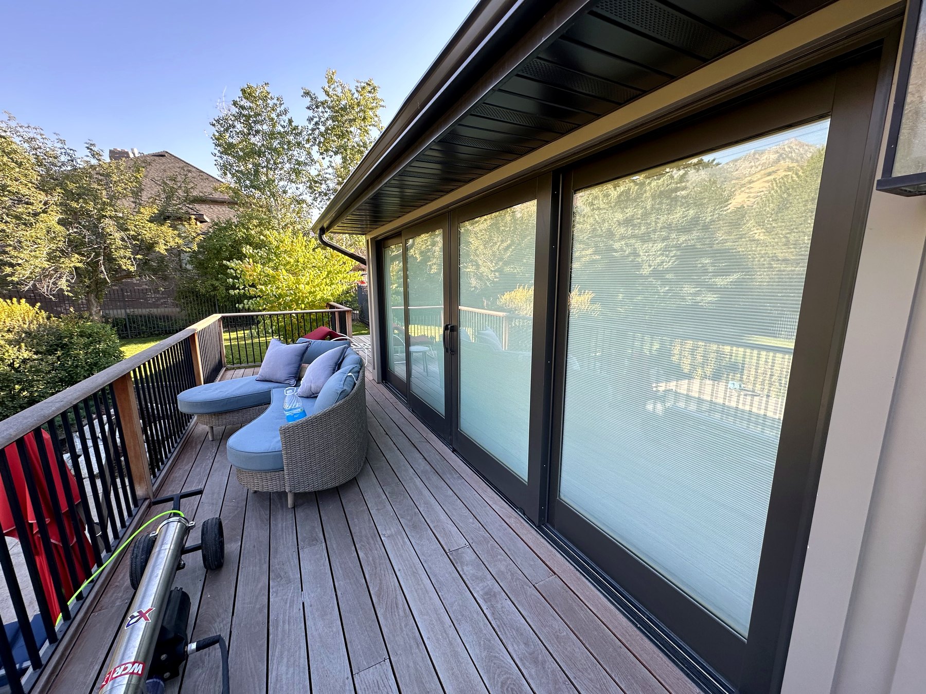 Large sliding glass doors along a wood deck after cleaning