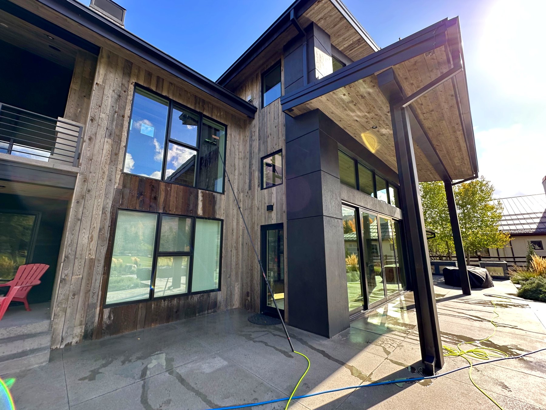 Exterior window cleaning on a modern Charlotte home in daylight