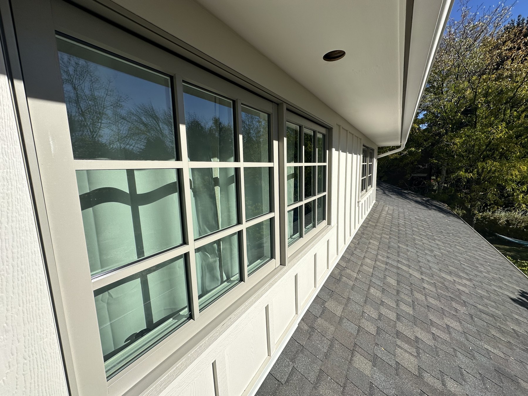 Clean upper-level windows with white trim above a roofline