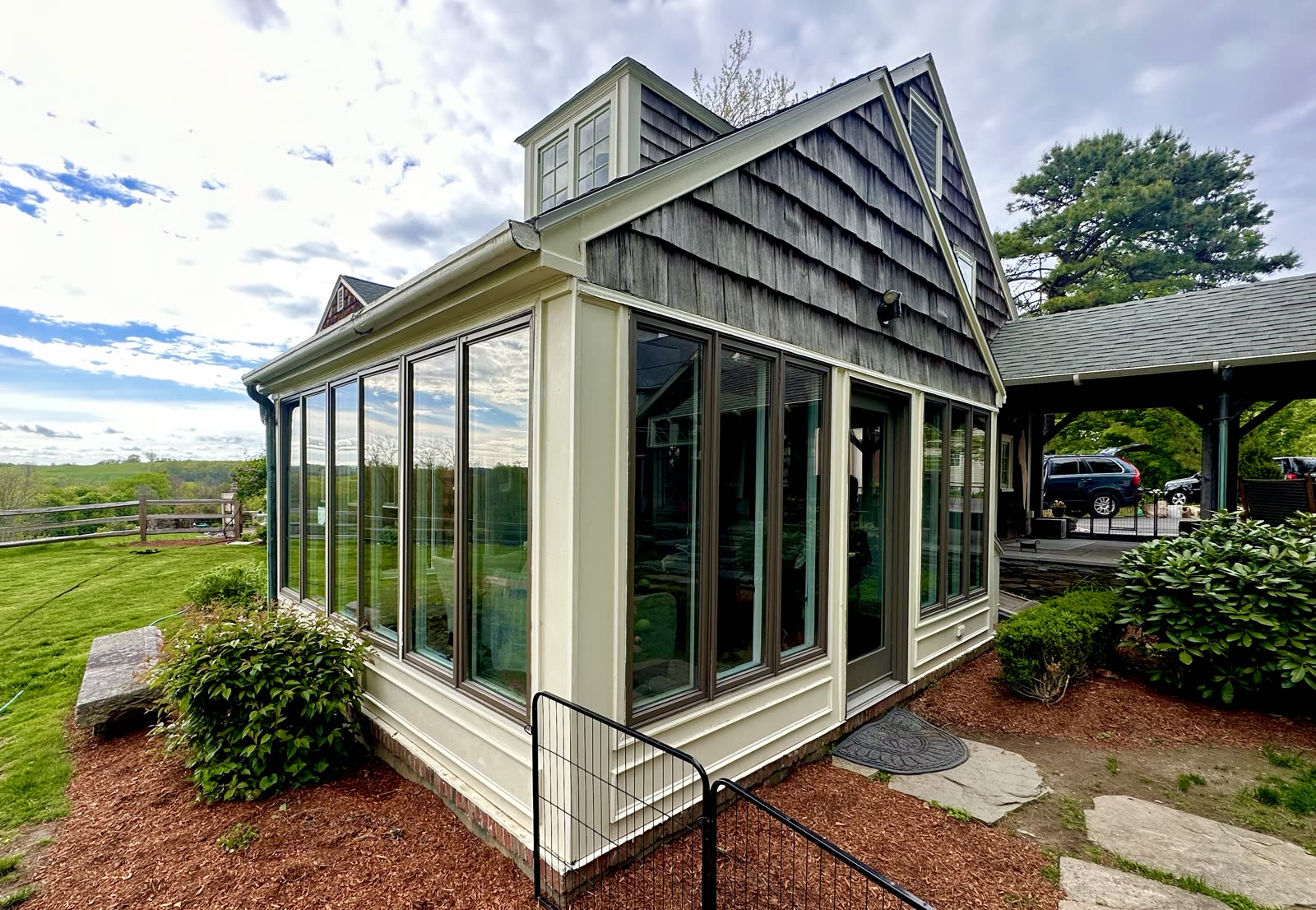 Sunroom with clean glass panels and bright white trim